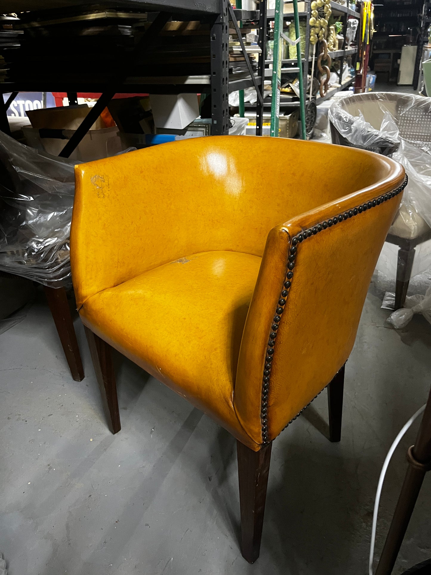 YELLOW ORANGE LEATHER CLUB CHAIR WITH RIVETS
