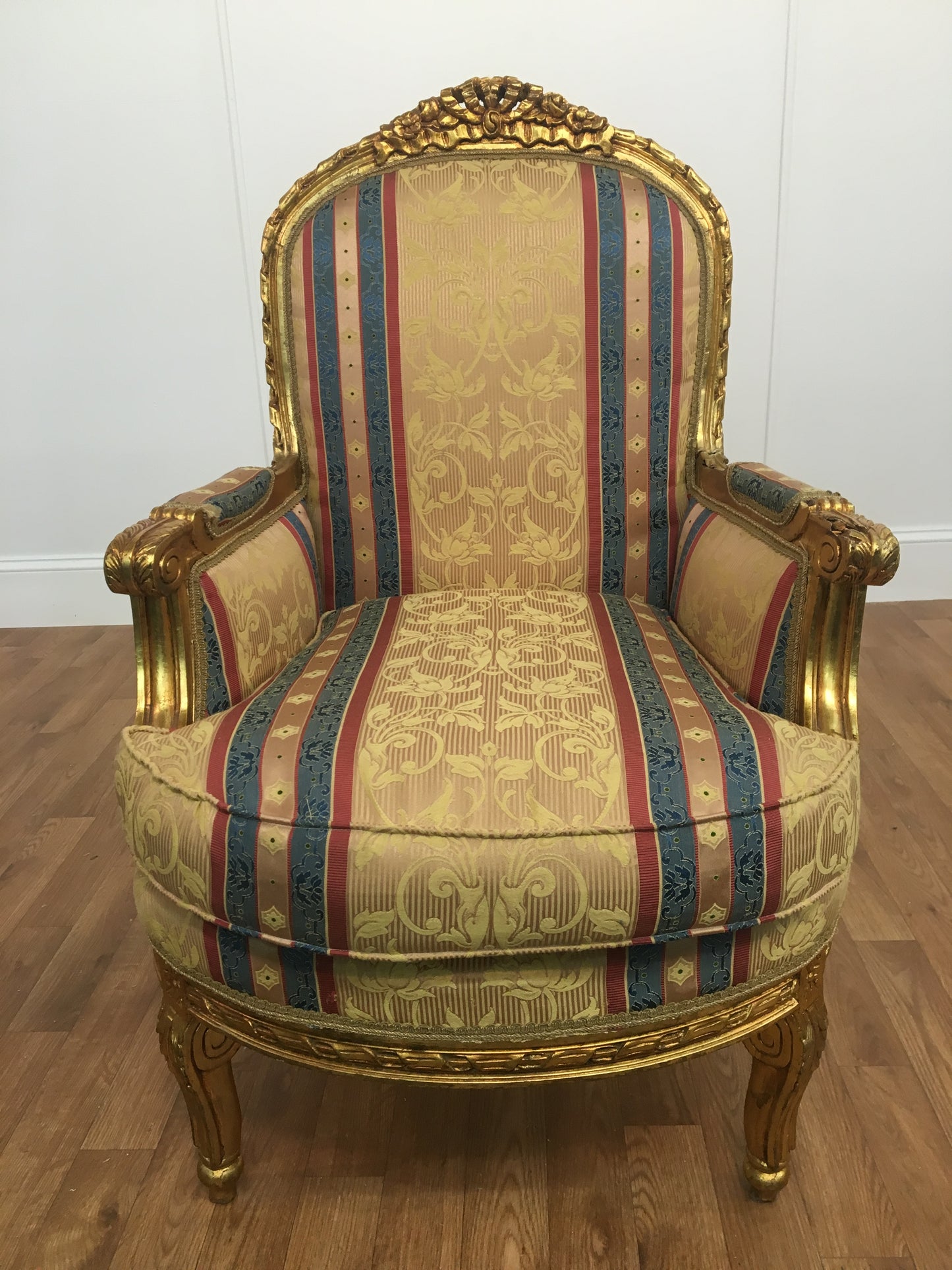 RED, GOLD  AND BLUE STRIPED ORNATE ARM CHAIR