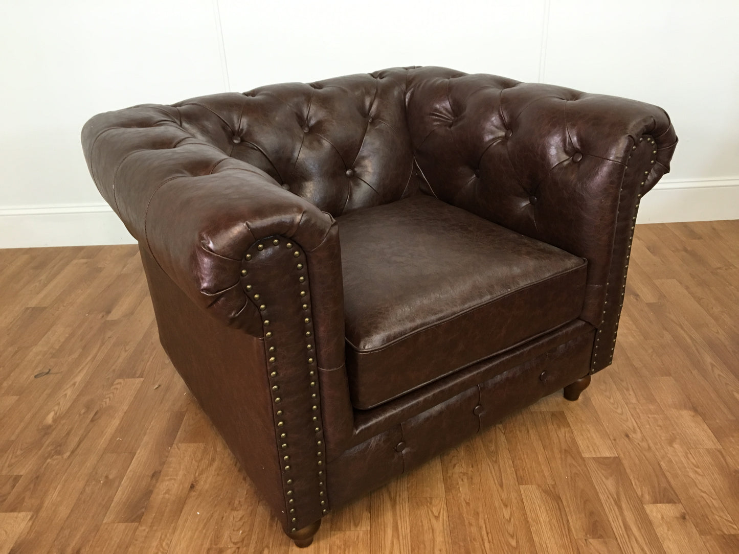 BROWN LEATHER ARM CHAIR WITH RIVETS